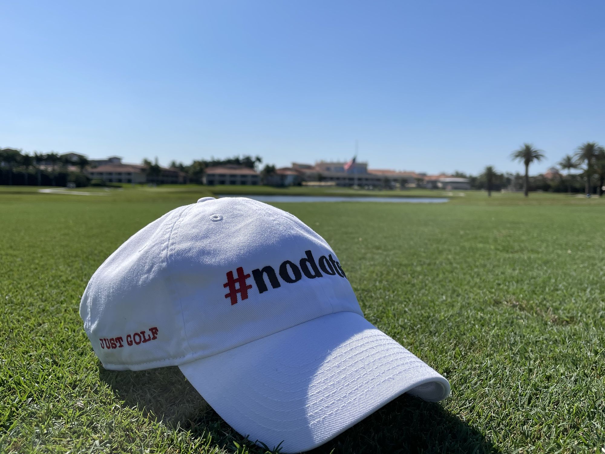 A white #nodots hat on the fairway